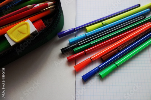 Colorful pens, pencil case and empty notebook. School. 