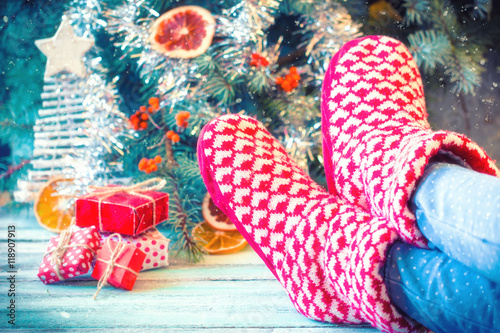 Woman relaxes her feet in woollen socks.Winter and Christmas holidays concept.