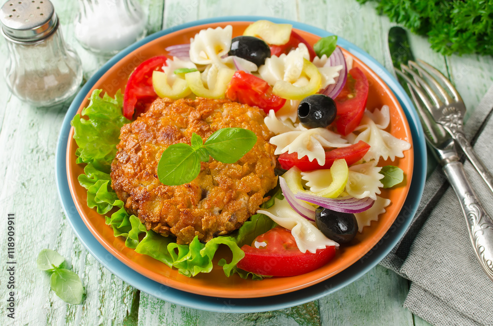 Breaded fried pork cutlet served with pasta salad Breaded fried pork cutlet served with pasta salad