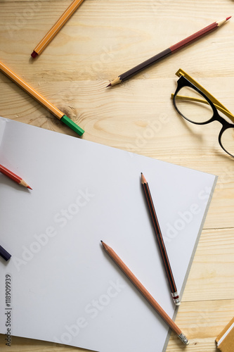 Wallpaper Mural blank paper and colorful pencils and glasses on old wooden table with mornning light. Torontodigital.ca