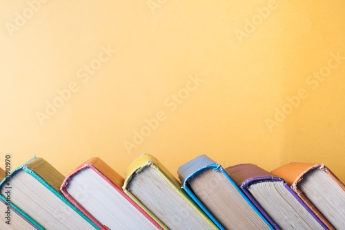 Stack of colorful books on table. Education background. Back to school. Copy space for text.