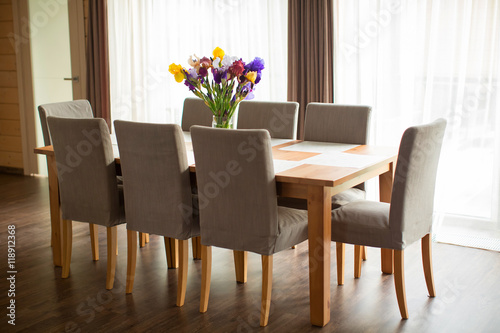 dining table with chairs in the dining room , a beautiful bouque