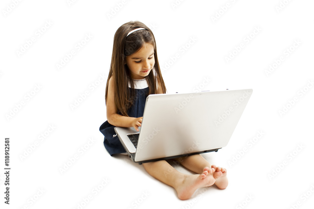 Adorable little girl is sitting on floor with her laptop. Isolated on white background Adorable little girl is sitting on floor with her laptop. Isolated on white background