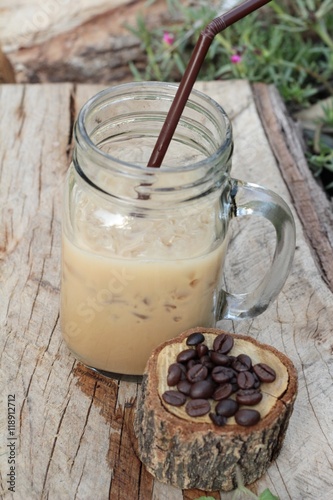Iced coffee is delicious on wood background.