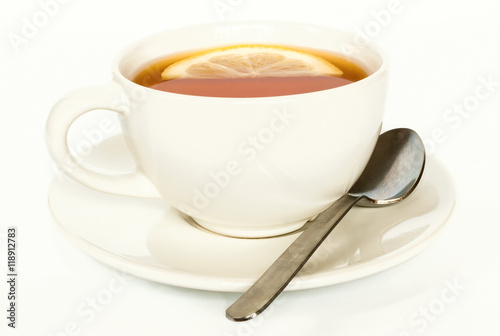Cup of lemon tea with a spoon. Selective focus  white background.