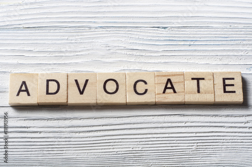 Advocate word written on wood abc block at wooden background