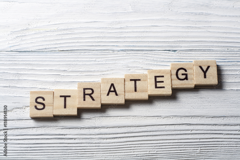 Fototapeta premium Strategy word on wooden cubes, success in business concept.