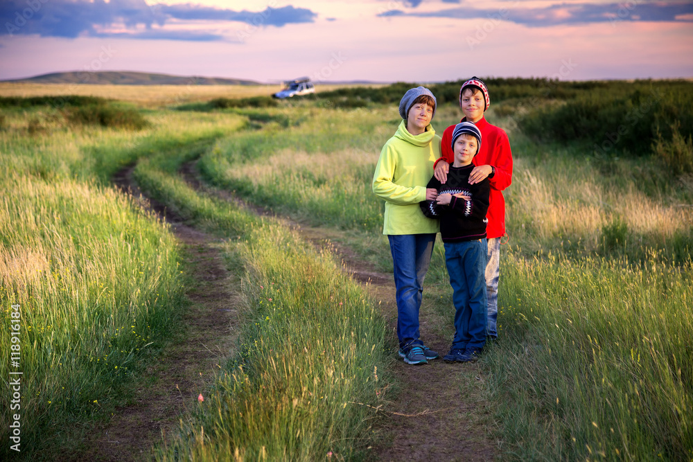 Family traveler posing at sunset near the camp on the prairie Family traveler posing at sunset near the camp on the prairie