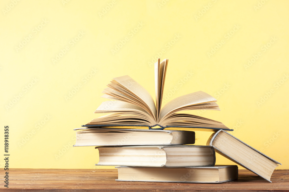 Fototapeta premium Open book, hardback books on wooden table. Education background. Back to school. Copy space for text.