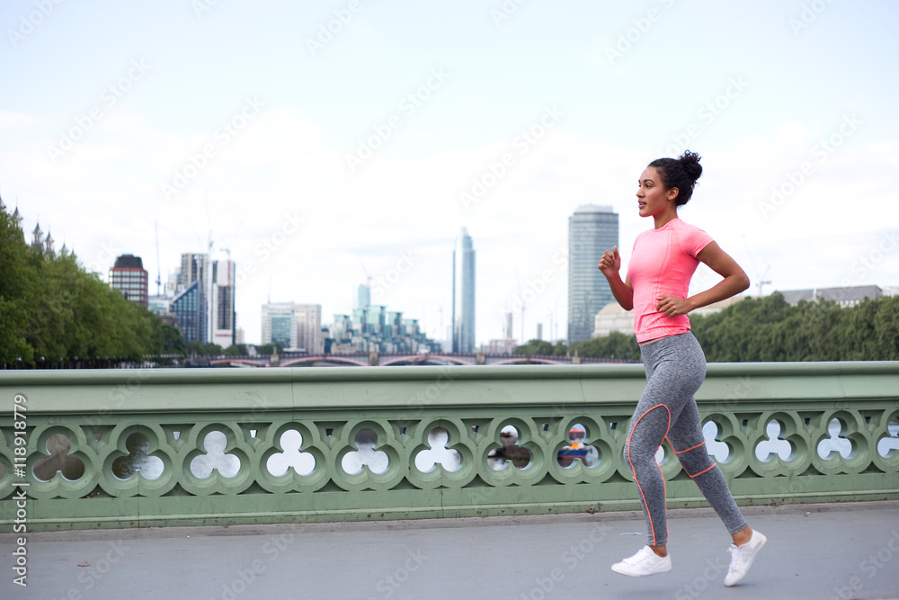 young woman running across westminster bridge.