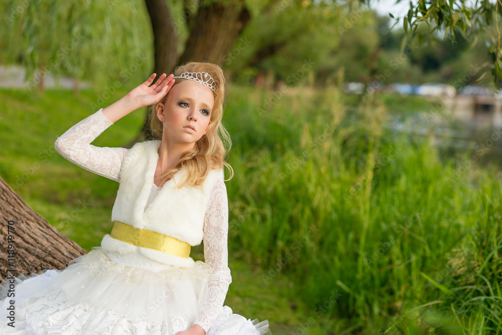 Fashion photo of a young girl in a beautiful white dress Fashion photo of a young girl in a beautiful white dress