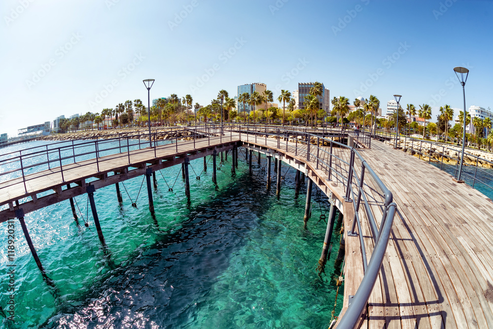 Obraz premium View of Molos Promenade from the wooden pier on the coast of Lim
