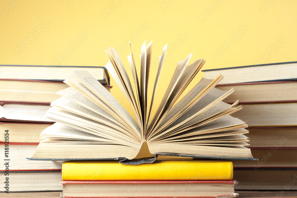 Fototapeta premium Open book, hardback books on wooden table. Education background. Back to school. Copy space for text.