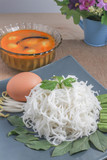 close up to Thai vermicelli eaten with curry, egg, vegetable and flower 