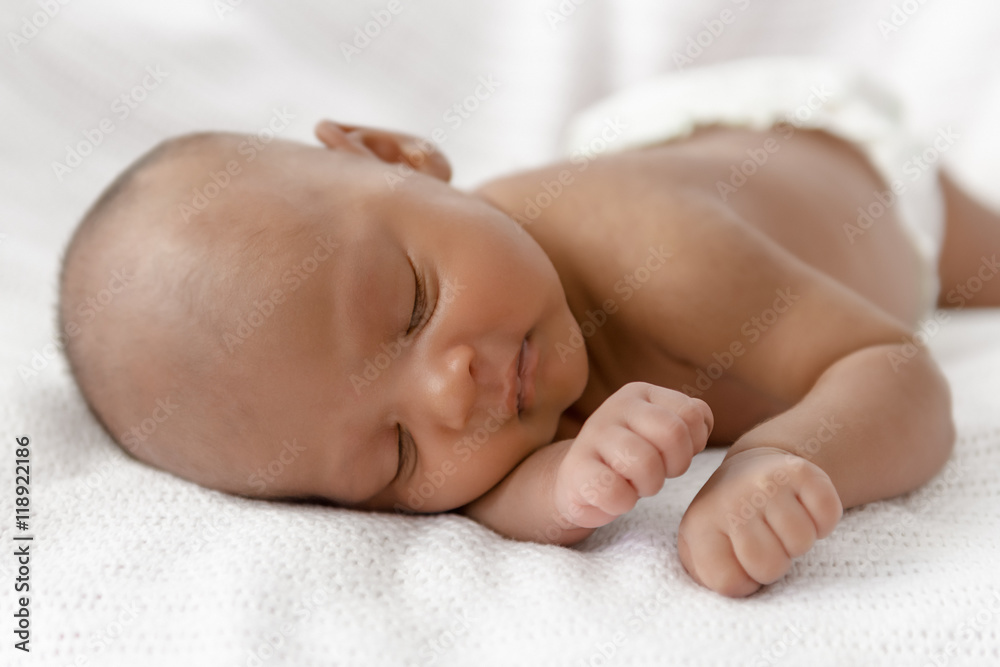 Three weeks old baby sleeping on white blanket cute infant newborn lying down close up shot eyes closed Three weeks old baby sleeping on white blanket cute infant newborn lying down close up shot eyes closed