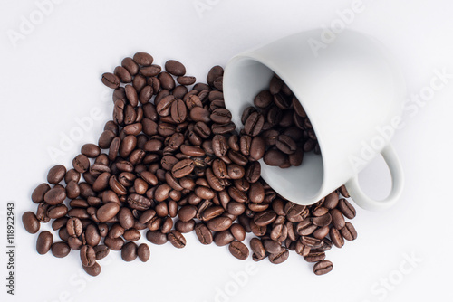 Cup of coffee arranged with fresh roasted coffee beans