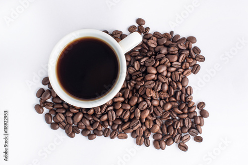 Cup of coffee arranged with fresh roasted coffee beans