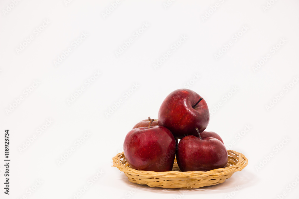 Ripe red apples in wicker basket isolated on white background Ripe red apples in wicker basket isolated on white background
