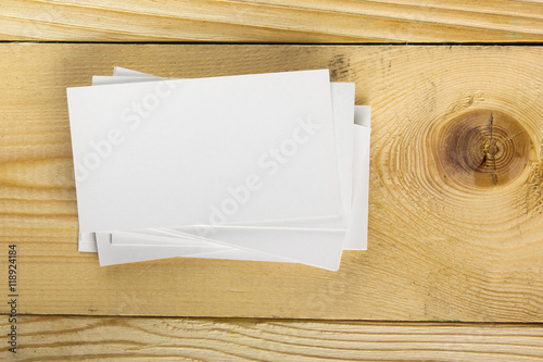 White blank business visit card  gift  ticket  pass  present close up on wooden background. Copy space corporate identity package Template for ID