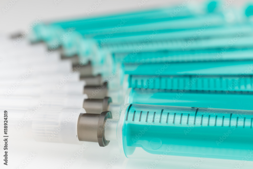 plenty of syringes on white background low focus plenty of syringes on white background low focus