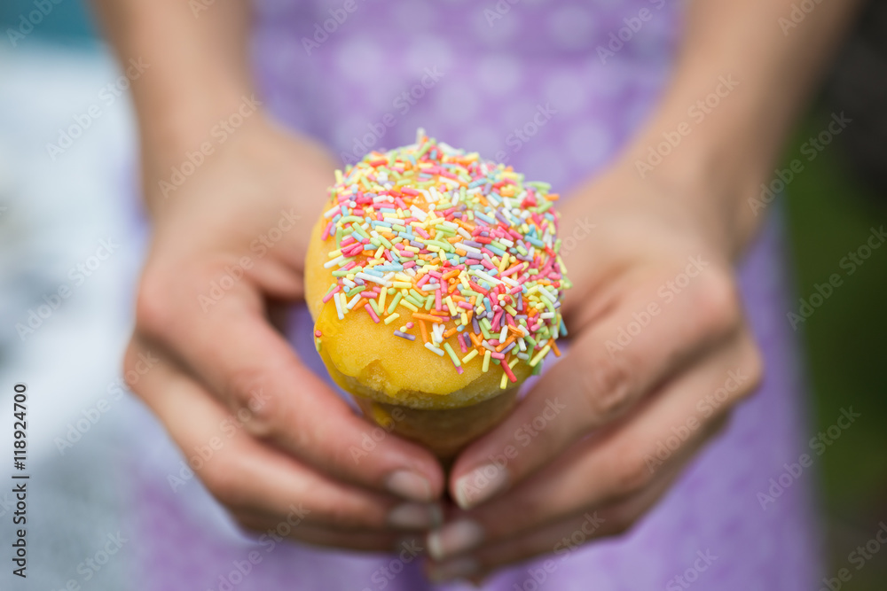 Ice cream with sprinkles held with two hands by lady Ice cream with sprinkles held with two hands by lady