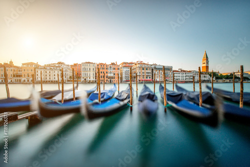 Canvastavla Venice cityscape view on Grand canal with colorful buildings, gondolas and San Marco campanille at the sunset