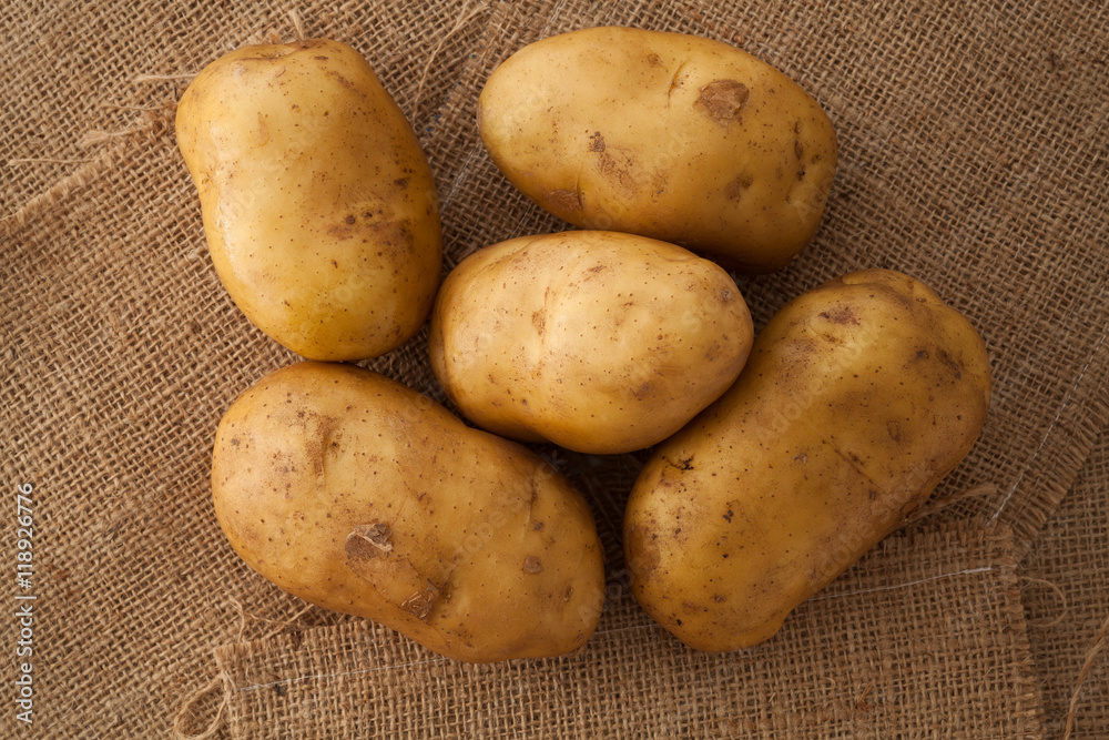 potato still life on sack background flat lay potato still life on sack background flat lay
