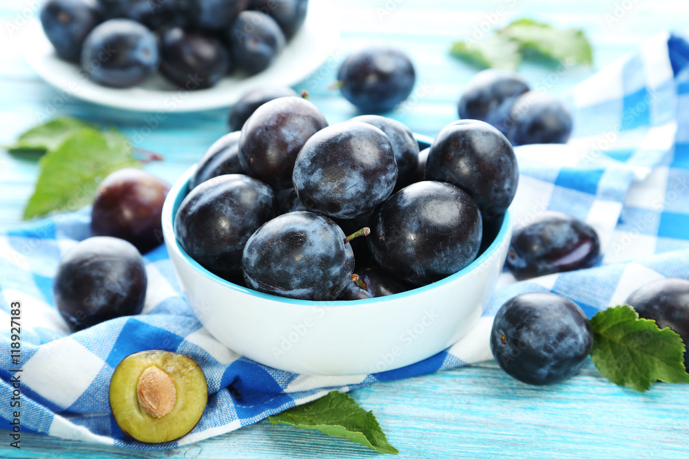 Tasty and ripe plums on blue wooden table Tasty and ripe plums on blue wooden table