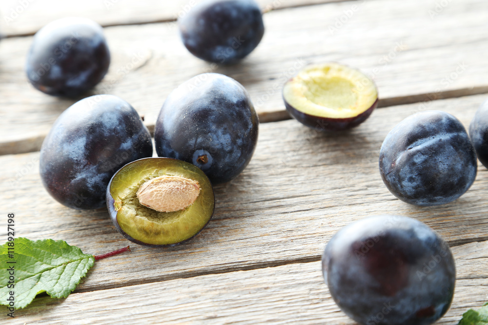 Tasty and ripe plums on grey wooden table Tasty and ripe plums on grey wooden table