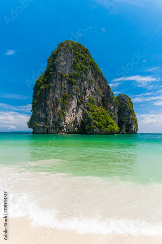 Long Tailed Boat in the beautiful beach of railay krabi. In the background the typical rock formation  that caractherize krabi province