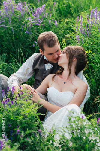 portrait of the bride and groom resting on a lavender background