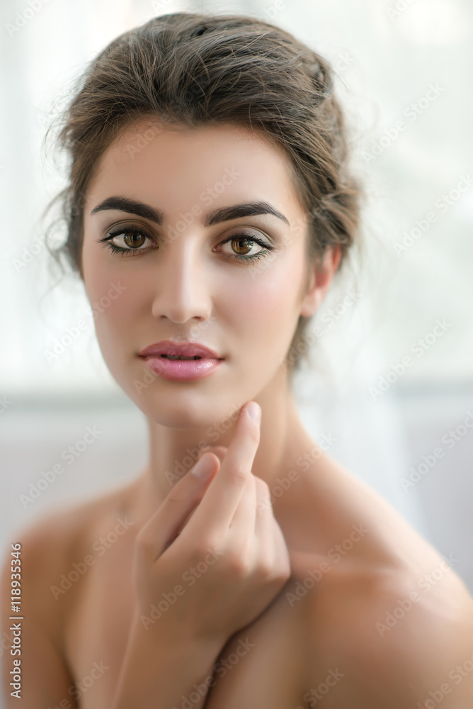 Beauty model with make up and fresh skin is posing front of the Beauty model with make up and fresh skin is posing front of the