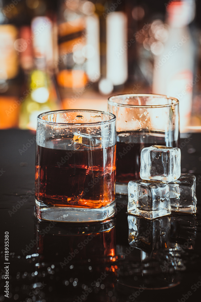 two glasses of whiskey on a blurred background bar two glasses of whiskey on a blurred background bar