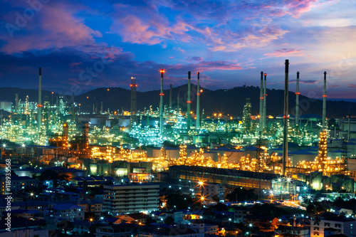 Oil refinery with tube and oil tank at sunset