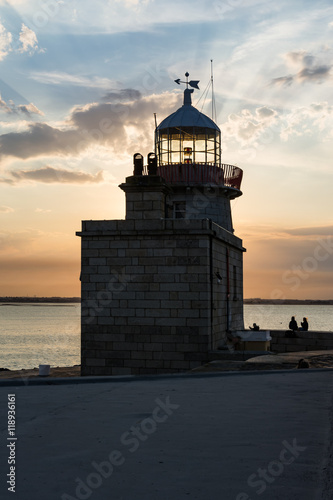 Warm Blue Orange Sunset Sky over Howth Lighthouse Tower Ireland