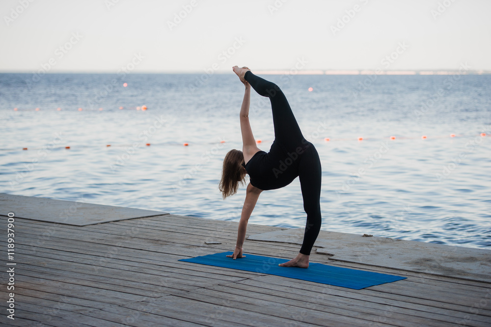 Image of a pretty woman doing yoga at the lake Stock Photo Adobe Stock