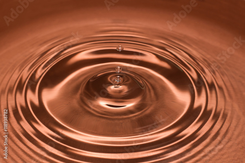 Drop of water, water splash in brown color.