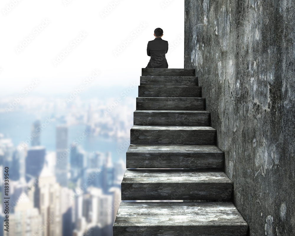 Rear view of man sitting on top of concrete stairs Rear view of man sitting on top of concrete stairs