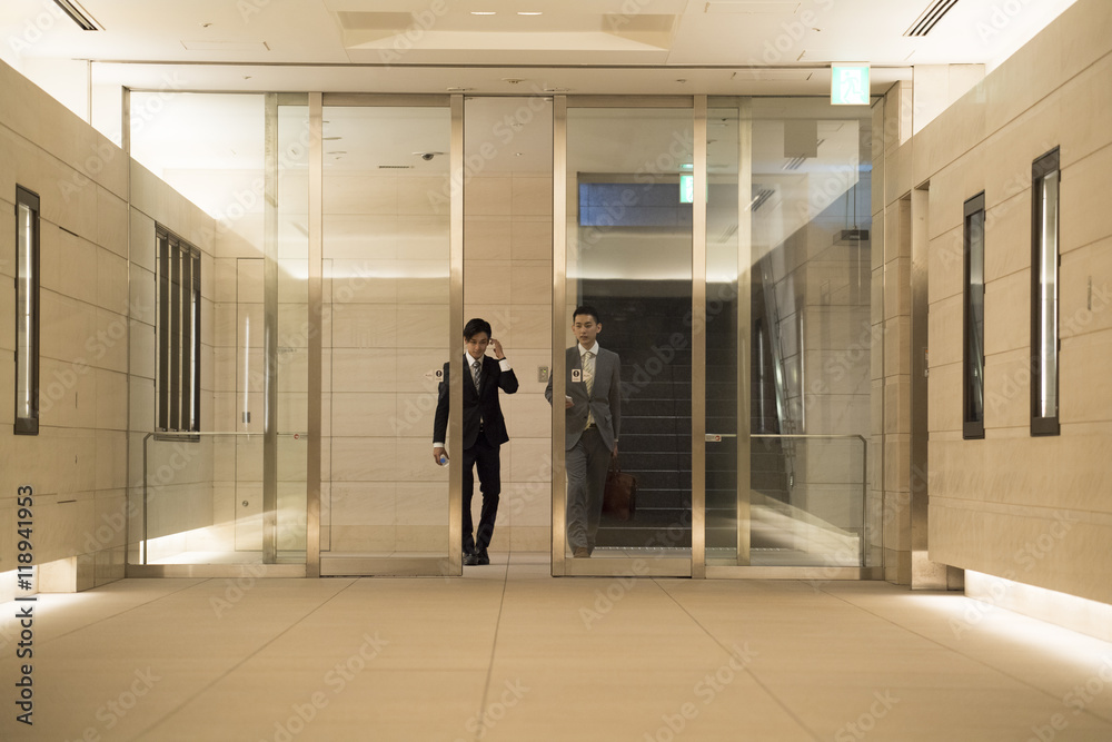 Businessman has entered the building while walking
