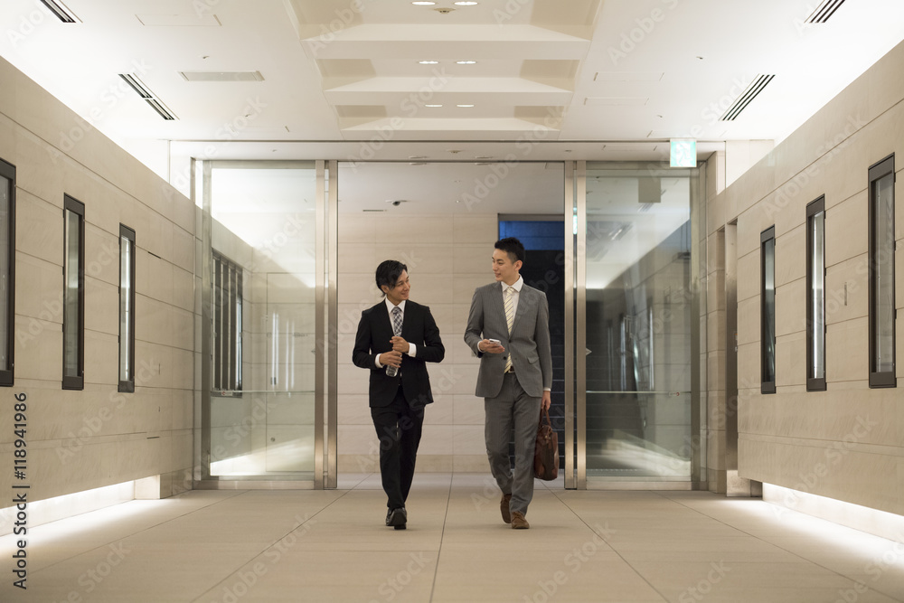 Businessman has entered the building while walking
