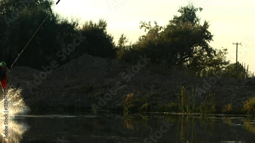 Slow motion shot of man wakeboarding photo