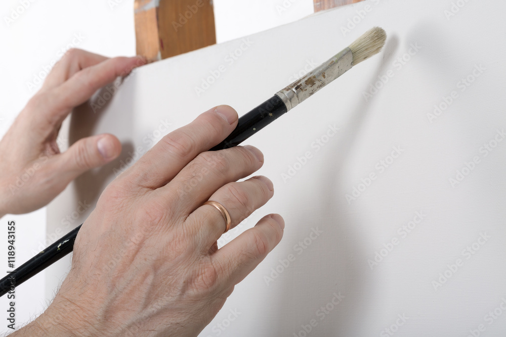 An artist hand painting in studio. Selective focus An artist hand painting in studio. Selective focus