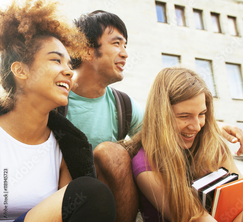 cute group teenages at the building of university