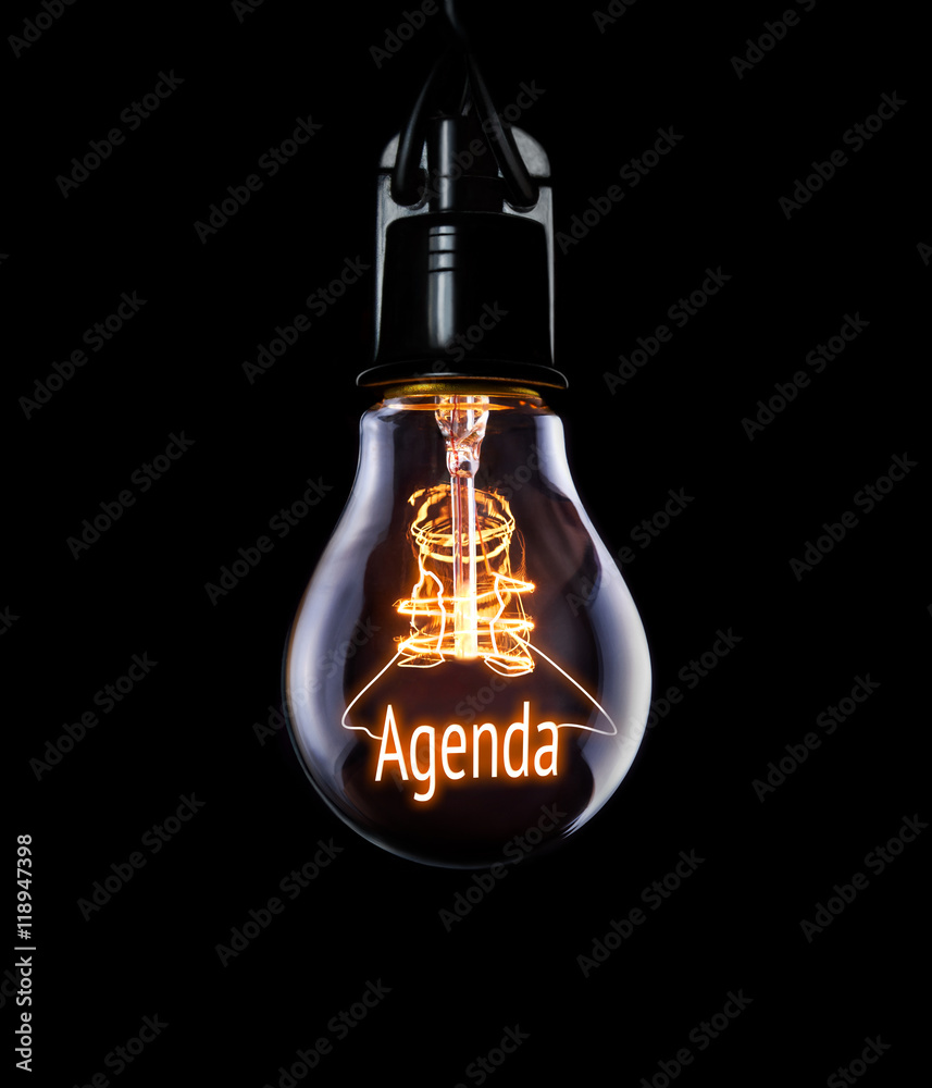 Hanging lightbulb with glowing Agenda concept.