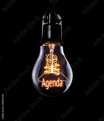Hanging lightbulb with glowing Agenda concept. photo