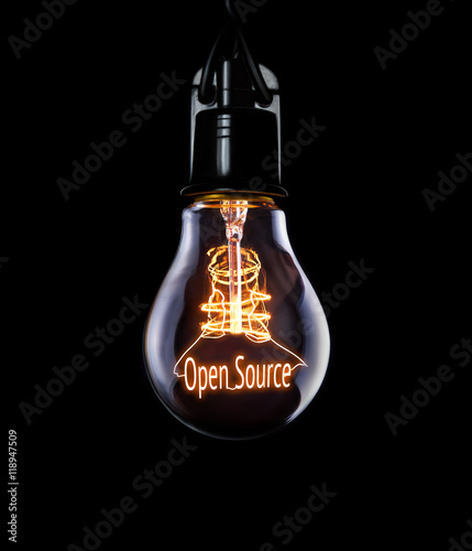 Billede på lærred Hanging lightbulb with glowing Open Source concept.