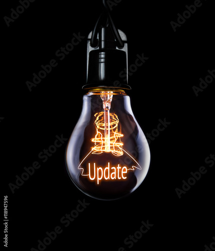Hanging lightbulb with glowing Update concept. photo