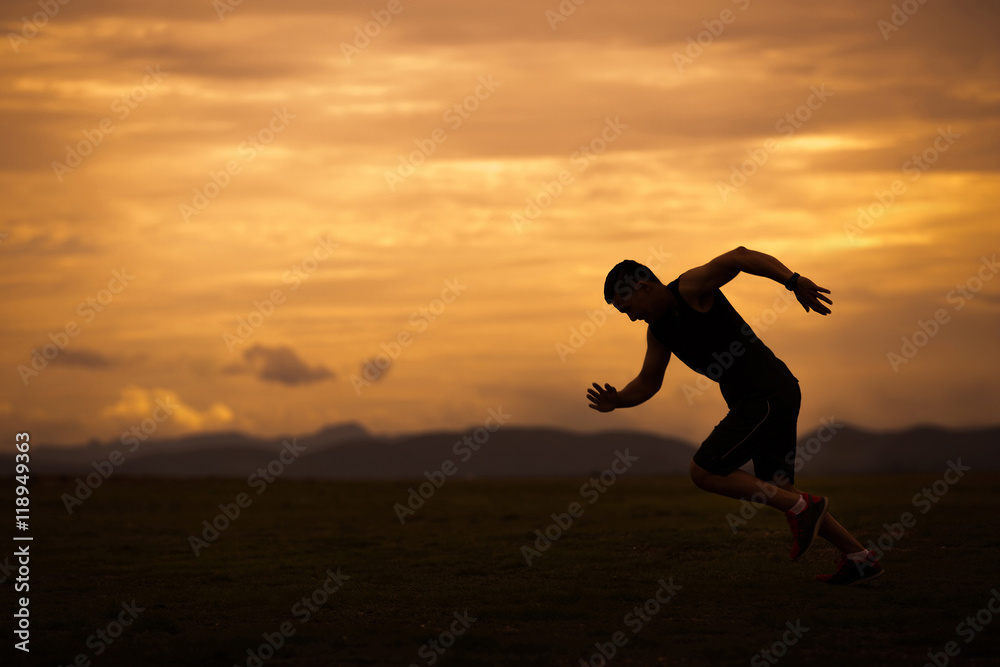 Asian men are siluate jogging at a speed in the evening