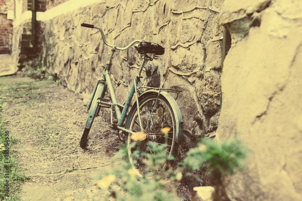 Vintage Bicycle Leaning against a brick Wall