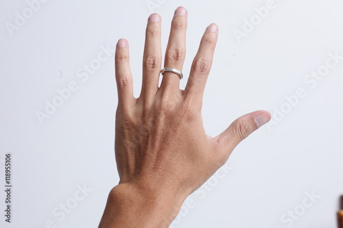 Close up hand with silver ring isolated on white background